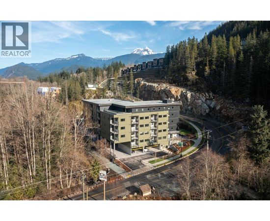 A large building with a mountain in the background.