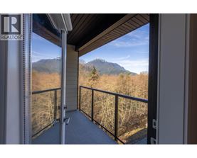 A balcony with a mountain view in the distance.