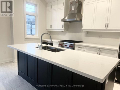 A kitchen with a white counter top and black cabinets.