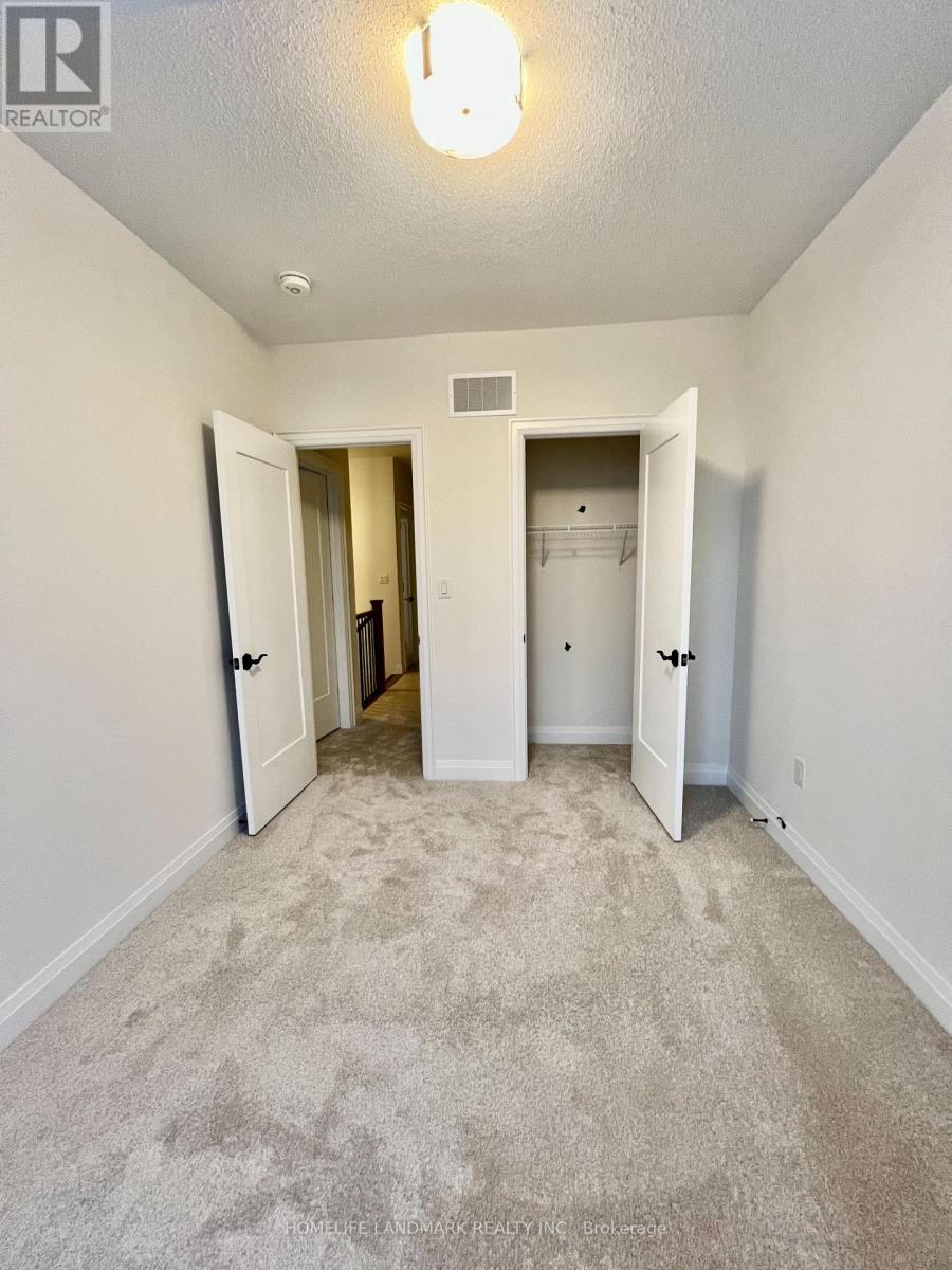 A realtor photo of a bedroom with carpeted floor and white walls.