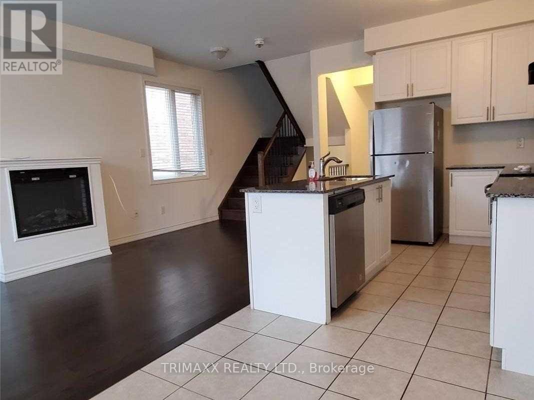 A kitchen with white cabinets and a black countertop.