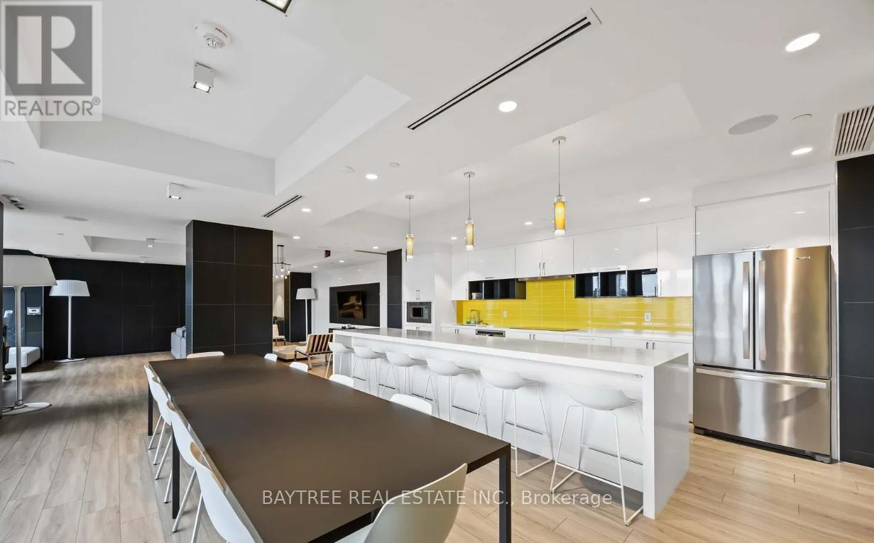 A modern kitchen with a long table and chairs.