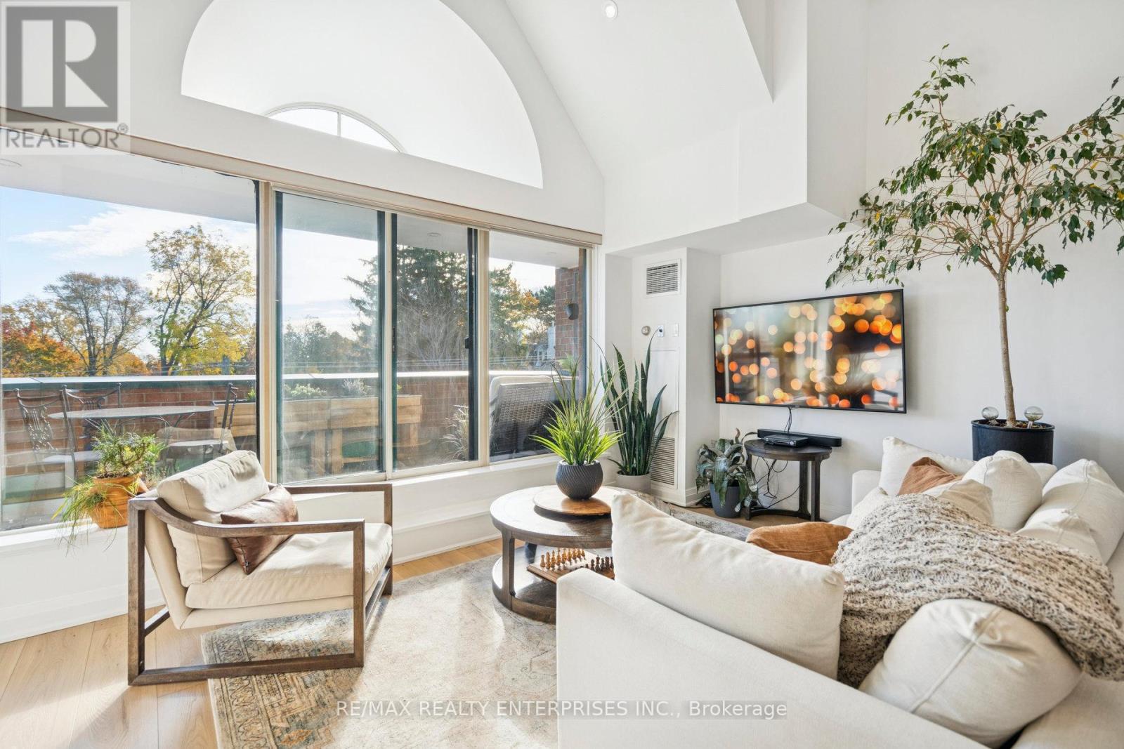 A living room with a couch, chair, and a large window.