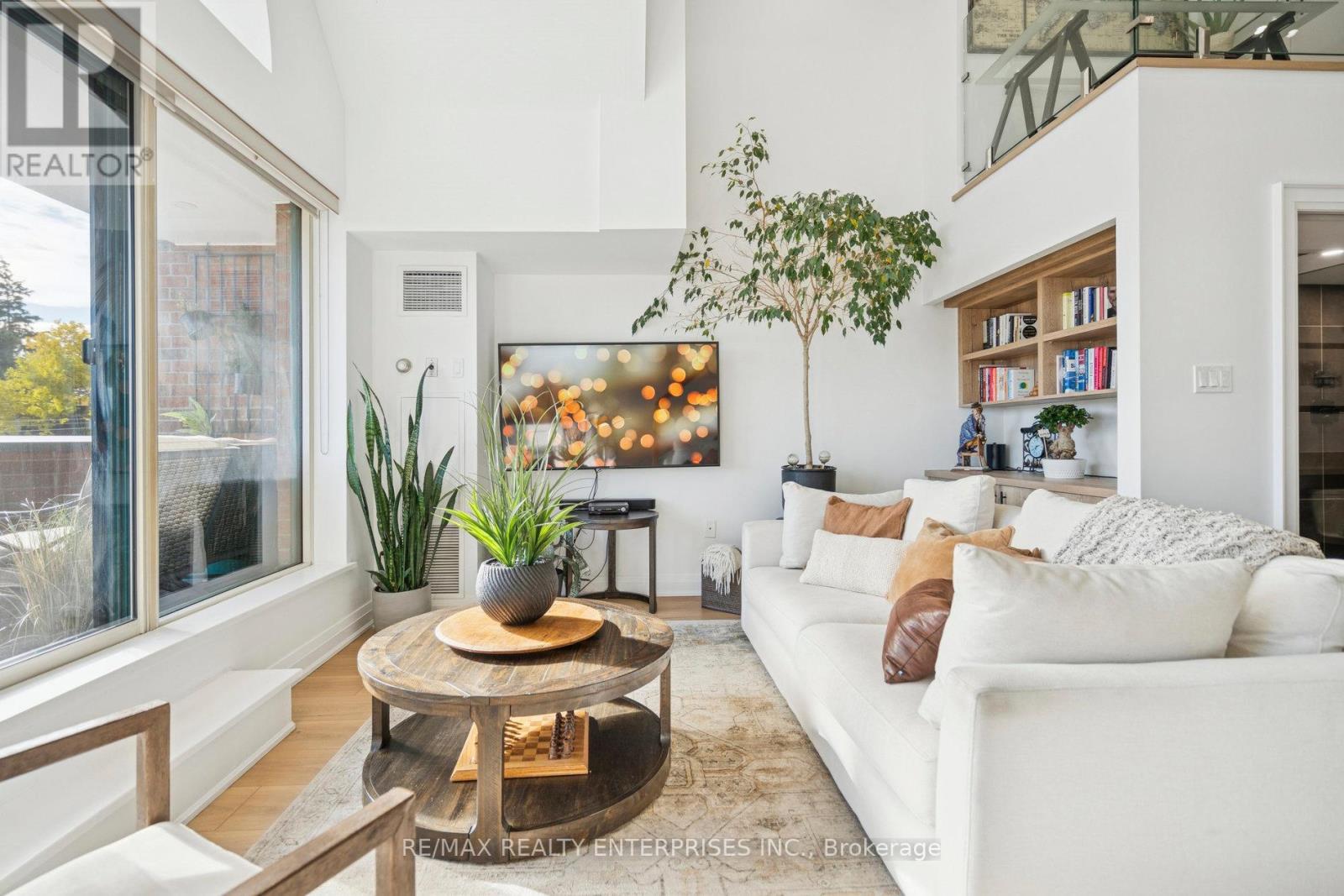 A living room with a white couch and a coffee table.