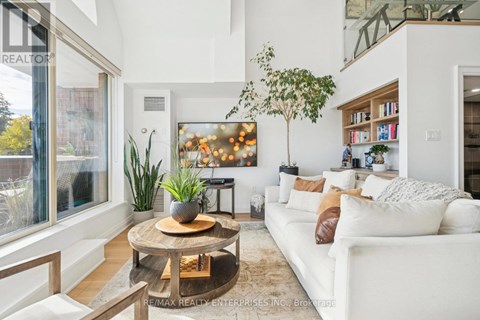 A living room with a white couch and a coffee table.