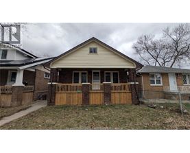 A house with a brown fence and a white roof.