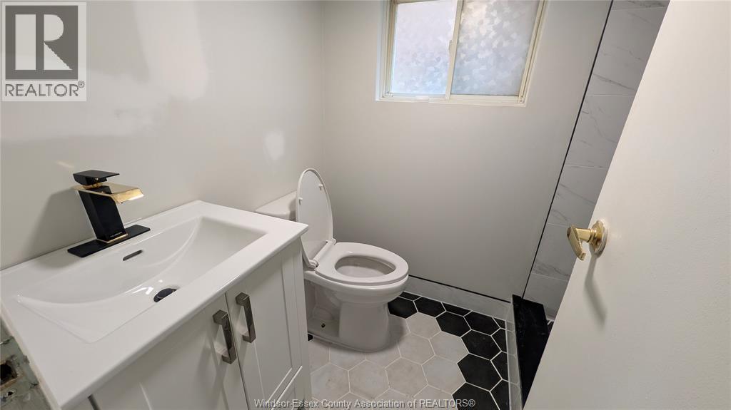A white sink and toilet in a small bathroom.