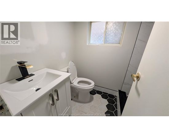 A white sink and toilet in a small bathroom.