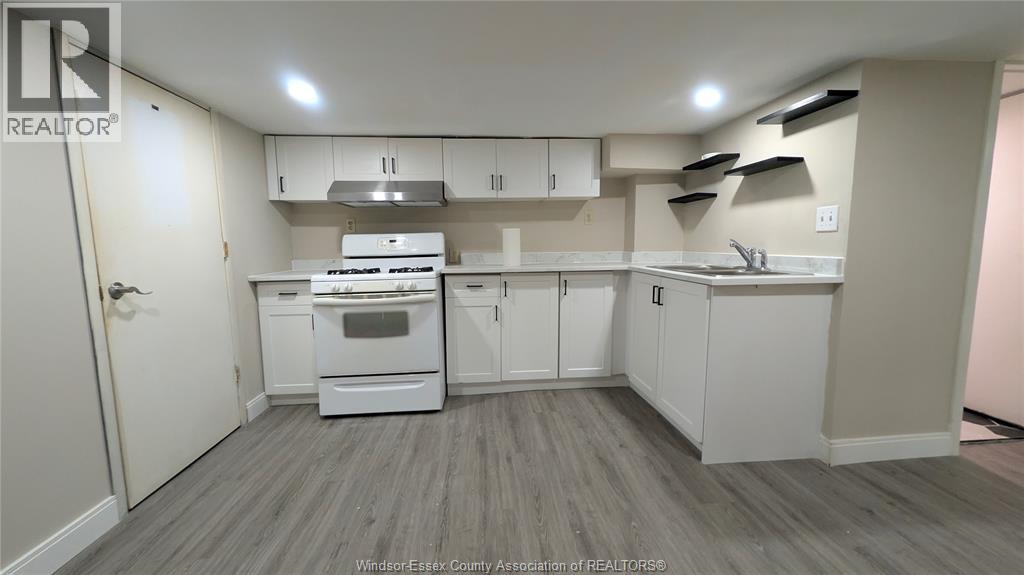 A kitchen with white appliances and cabinets.