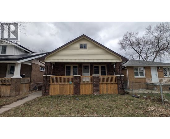 A house with a brown fence and a white roof.