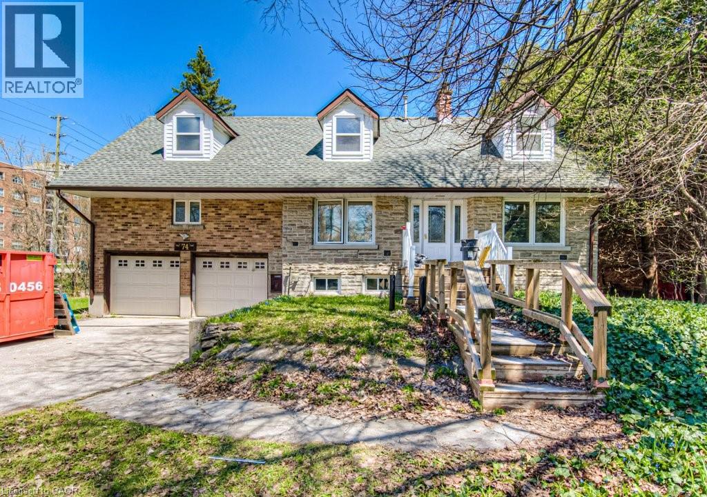 A house with a garage and a REALTOR sign in front.
