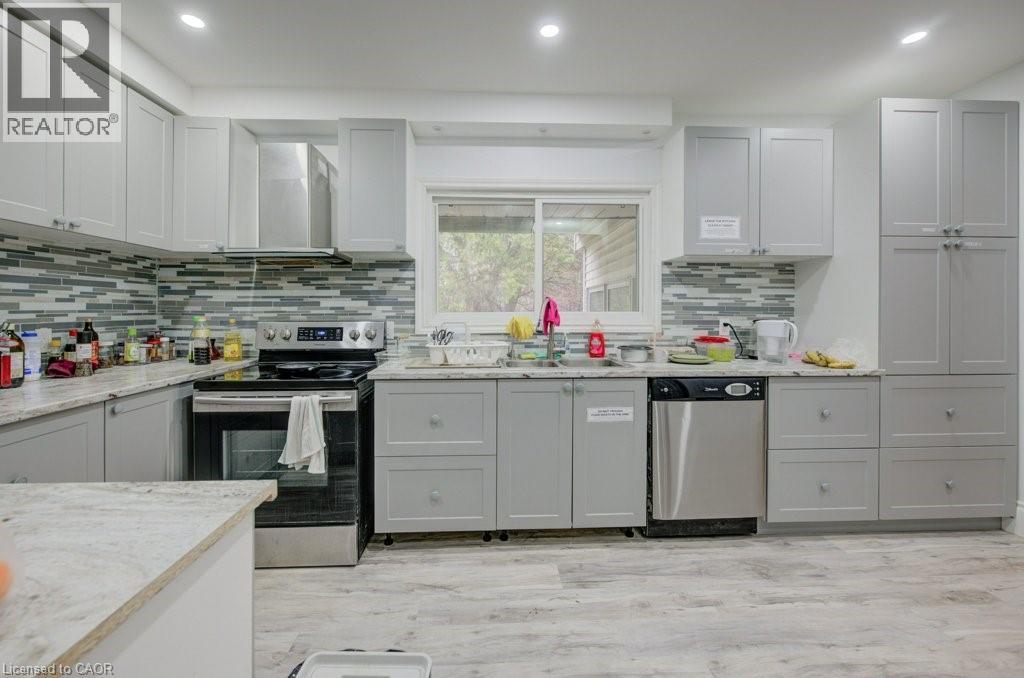 A kitchen with a white counter top and grey cabinets.