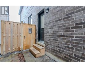 A wooden gate blocks the entrance to a brick building.