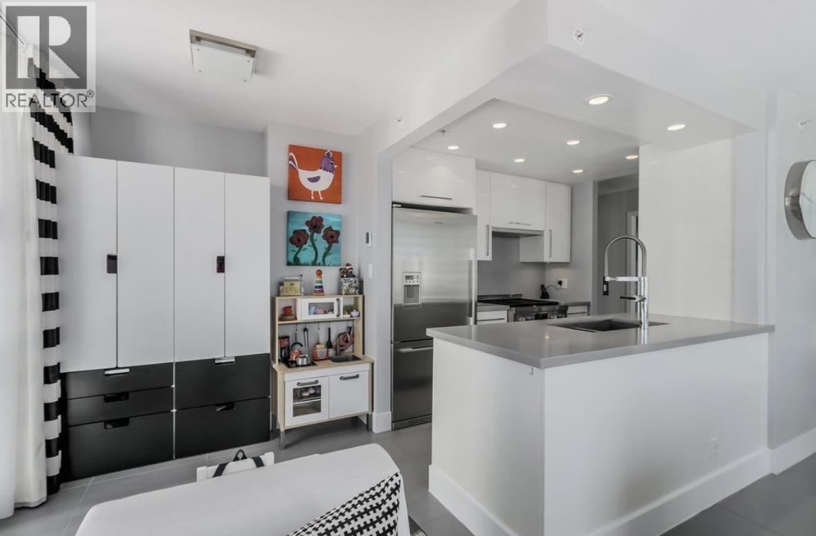 A modern kitchen with white cabinets and a black and white checkered bench.