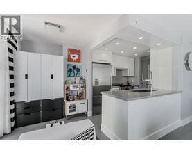 A modern kitchen with white cabinets and a black and white checkered bench.