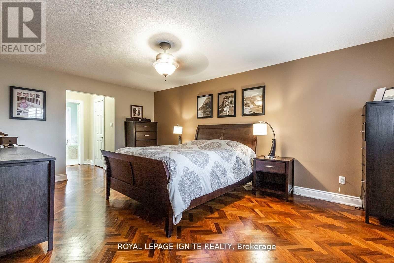A bedroom with a bed, nightstand, and dresser.