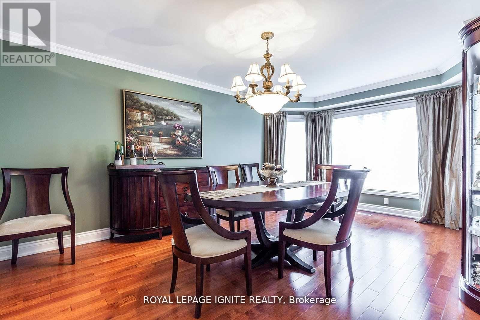 A dining room with a wooden table and chairs.