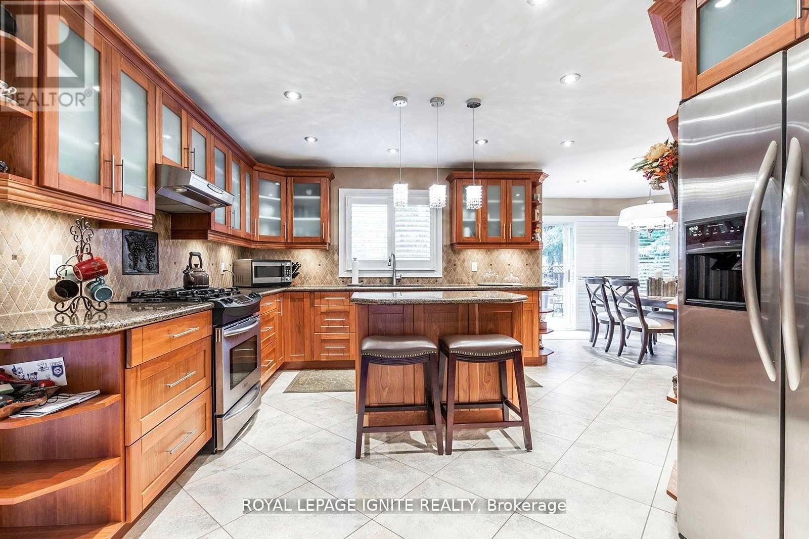 A kitchen with wooden cabinets and a central island.