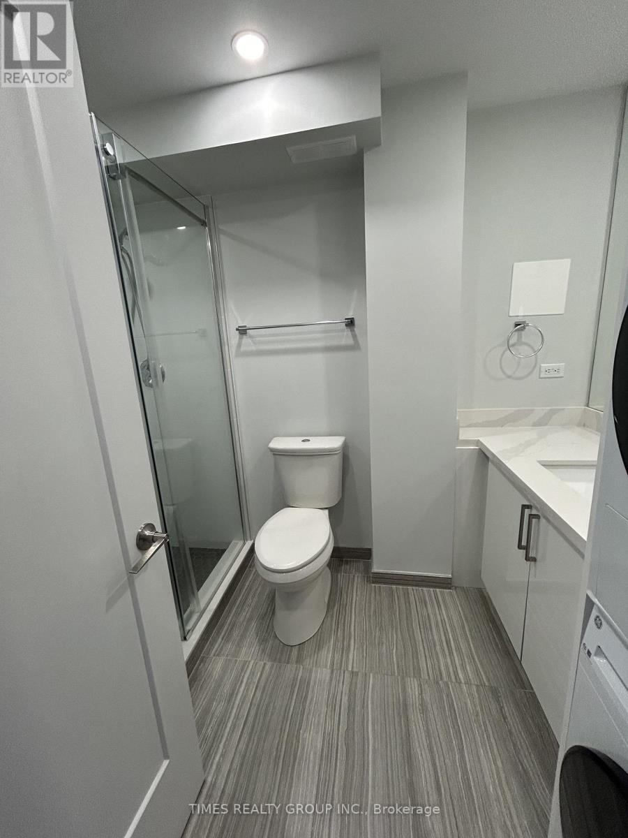 A bathroom with a toilet, sink, and mirror.