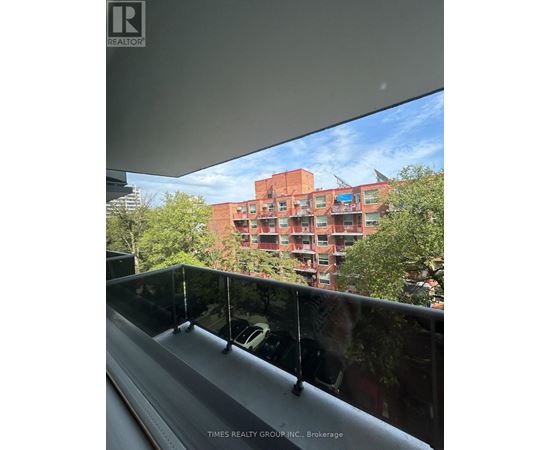 A building with a glass balcony in front of it.