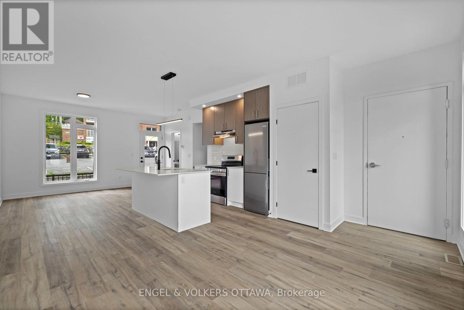 A realtor office with a white reception desk and a white framed picture on the wall.