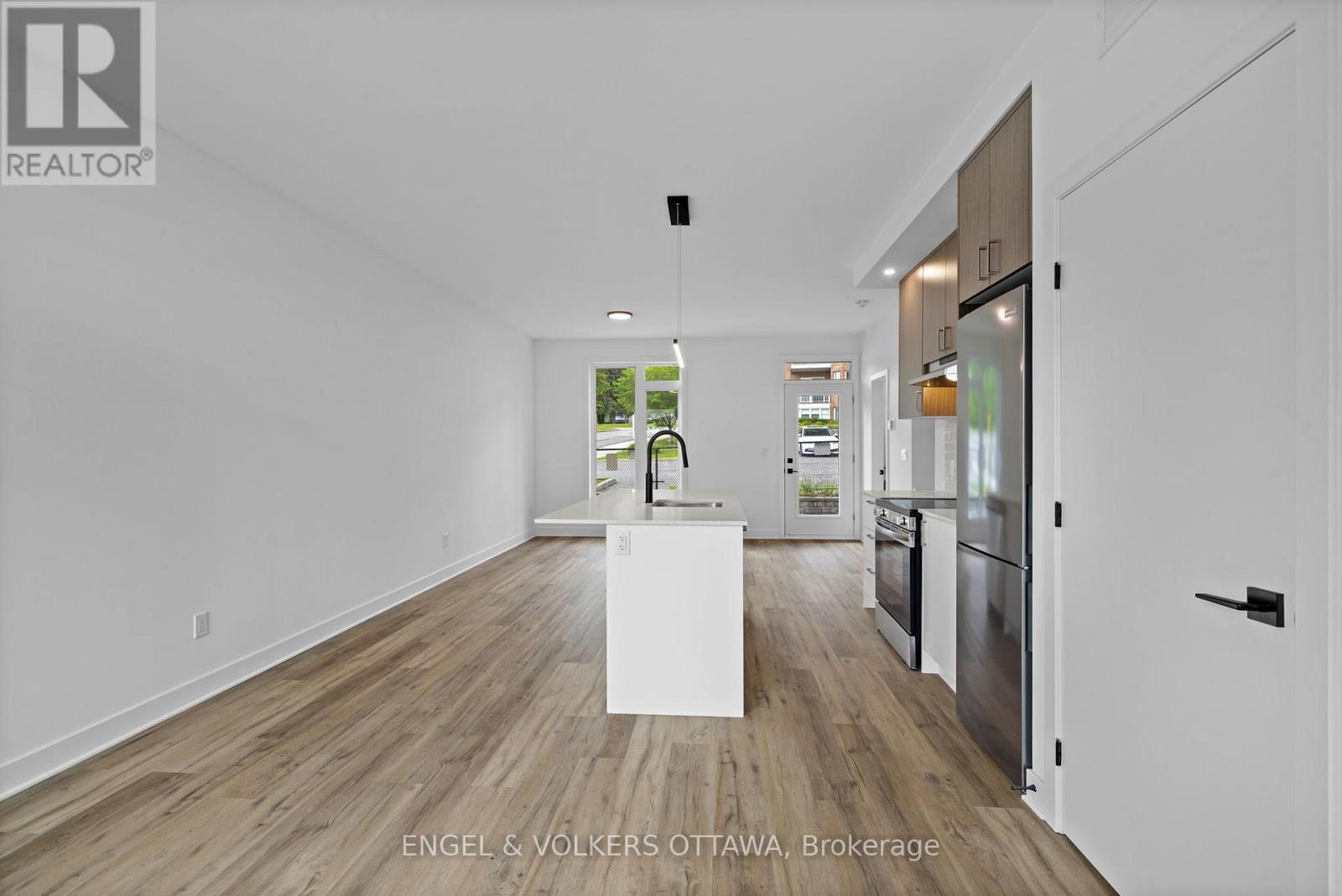 A realtor photo of a kitchen with a white island in the middle.