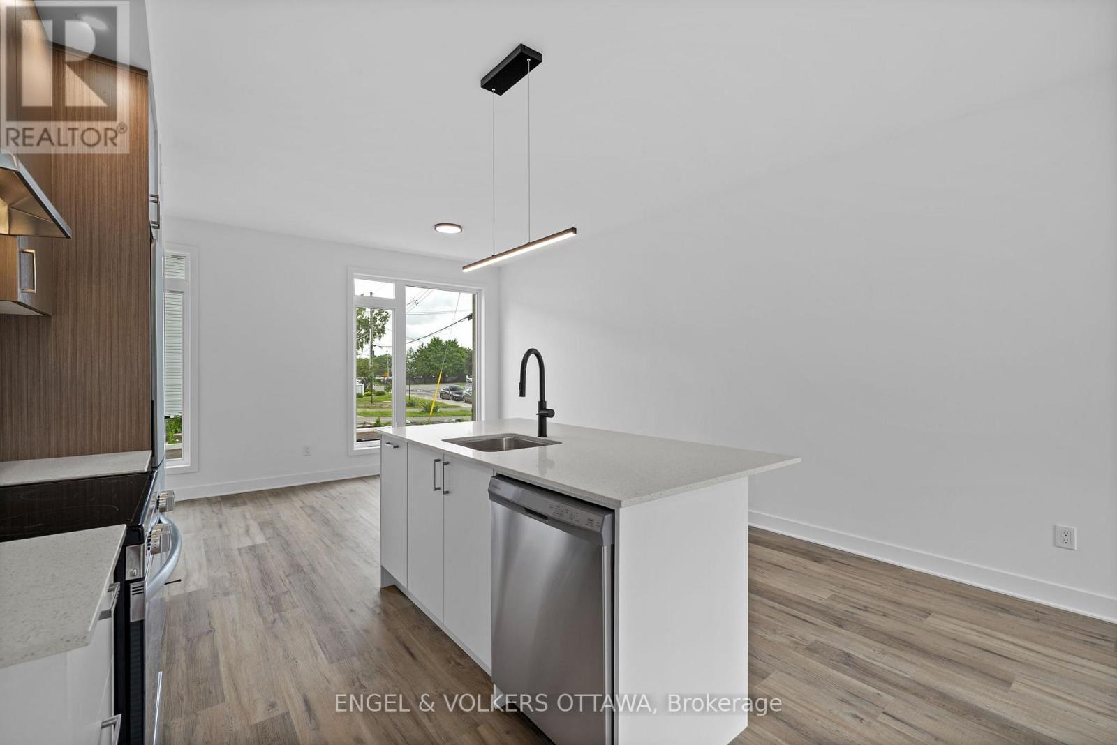 A modern kitchen with a dishwasher and a refrigerator.