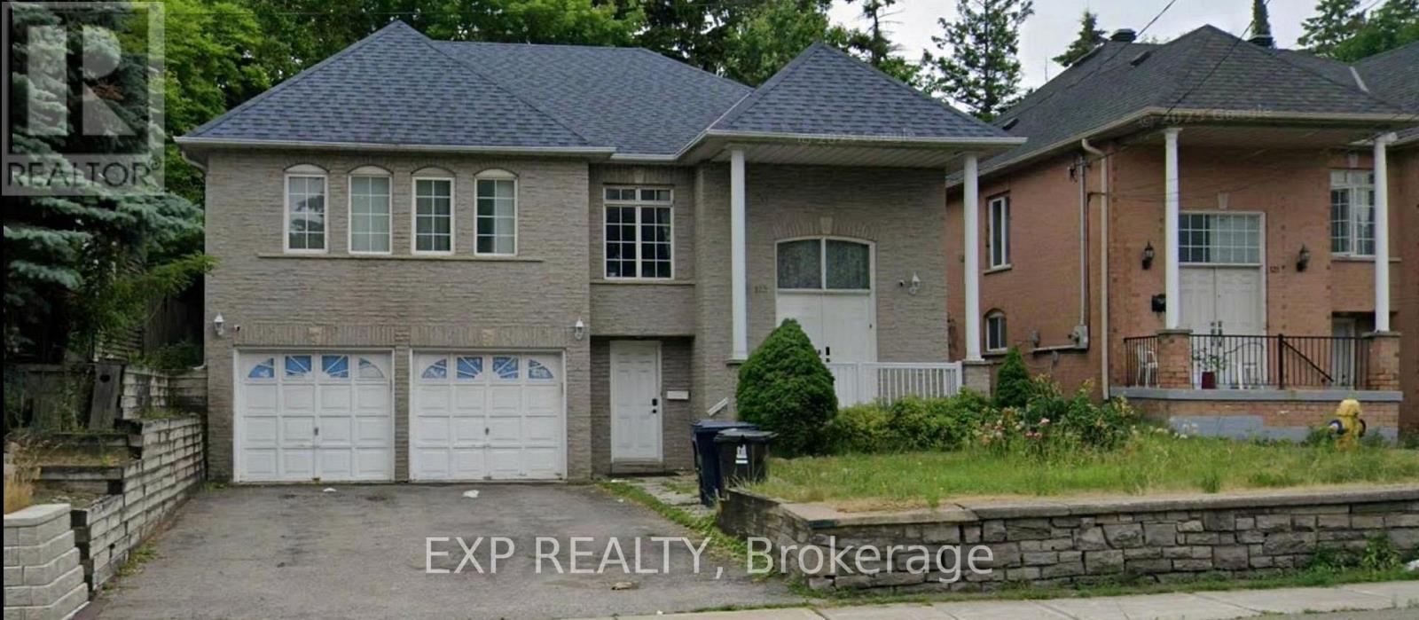 A house with a garage is for sale.