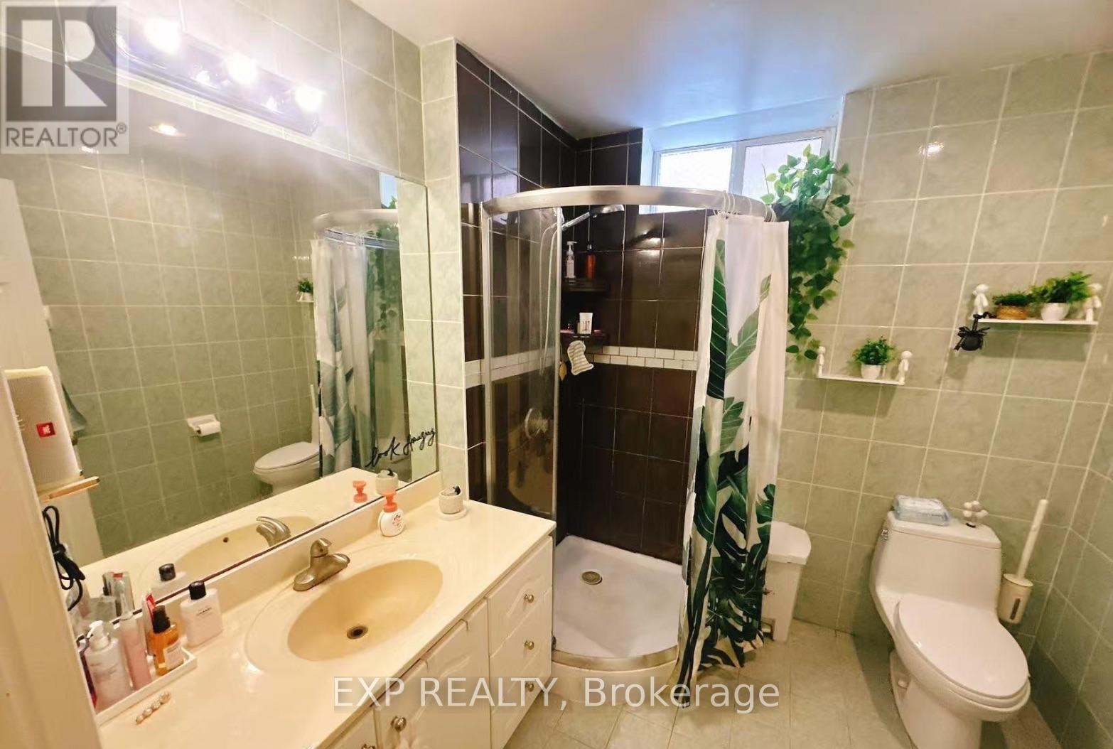 A bathroom with a sink, toilet, and shower.
