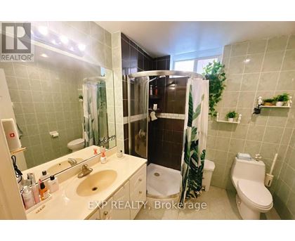 A bathroom with a sink, toilet, and shower.