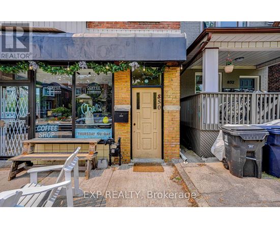 A coffee shop is located in a building with a brown door.