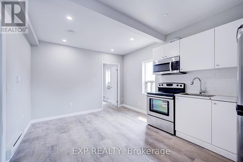 A kitchen with white cabinets and a stainless steel oven.
