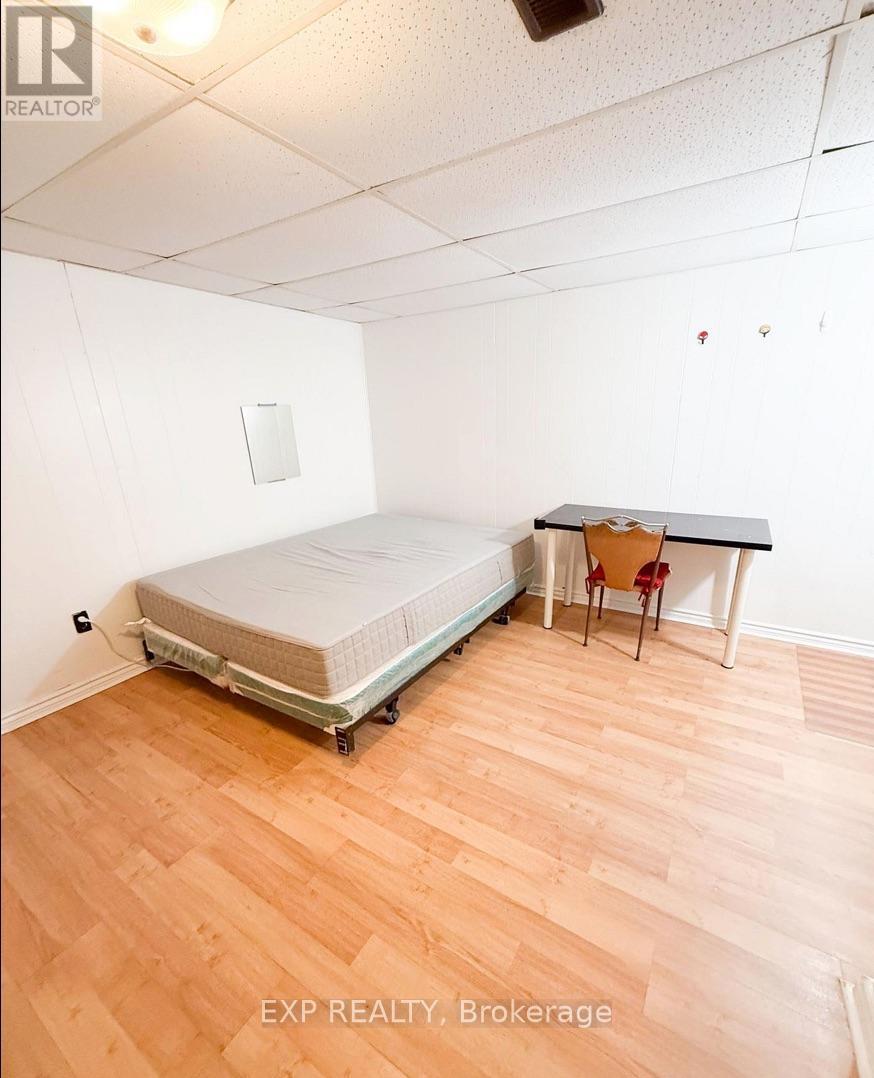 A bedroom with a bed, desk, and chair.