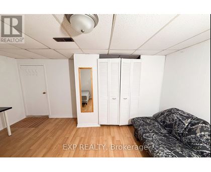 A room with a bed, a wardrobe, and a mirror.