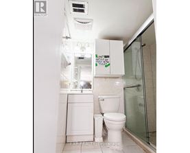 A white toilet with a sign above it that says "Leave no paper in the toilet.".