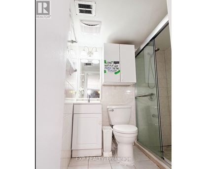 A white toilet with a sign above it that says "Leave no paper in the toilet.".