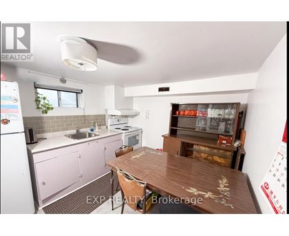 A kitchen with pink cabinets and a wooden table.