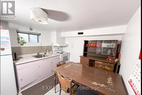 A kitchen with pink cabinets and a wooden table.