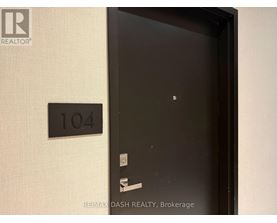 A black door with a number plate on the wall.