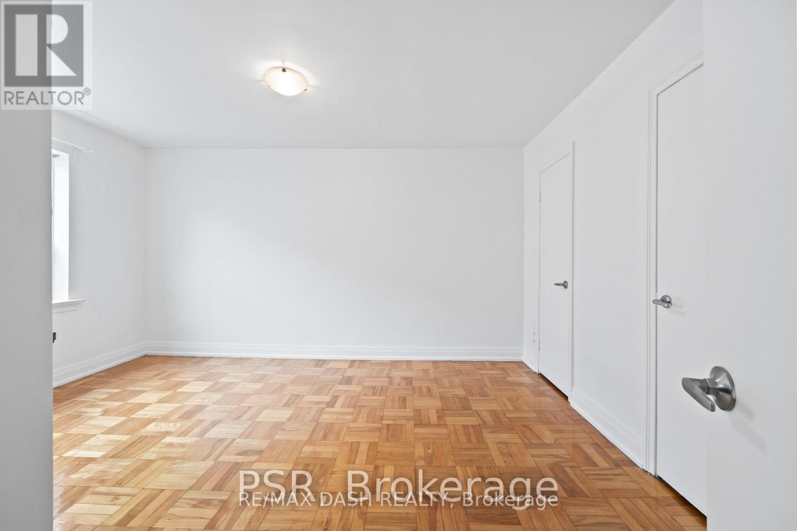 A room with a wooden floor and white walls.