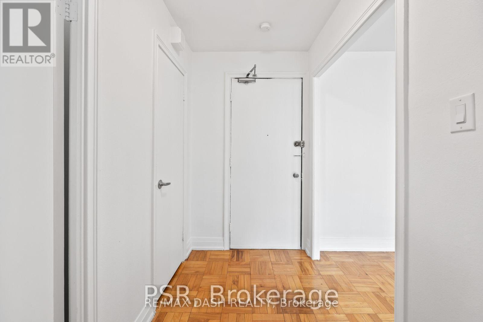 A hallway with a door on the right and a door on the left.