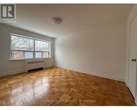 A room with a window and a radiator on the wall.
