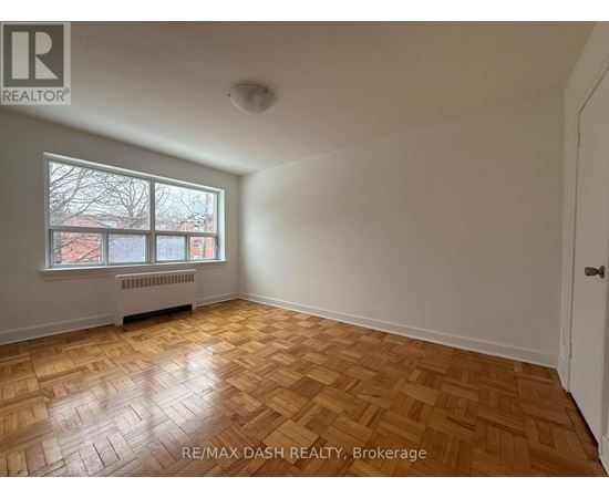 A room with a window and a radiator on the wall.