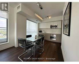 A modern kitchen with a glass table and chairs.