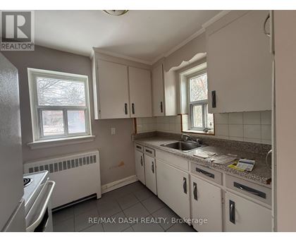 A kitchen with white cabinets and a granite countertop.