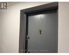 A door with a gold doorknob is in a white wall.