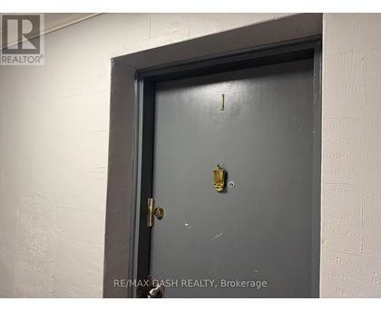 A door with a gold doorknob is in a white wall.