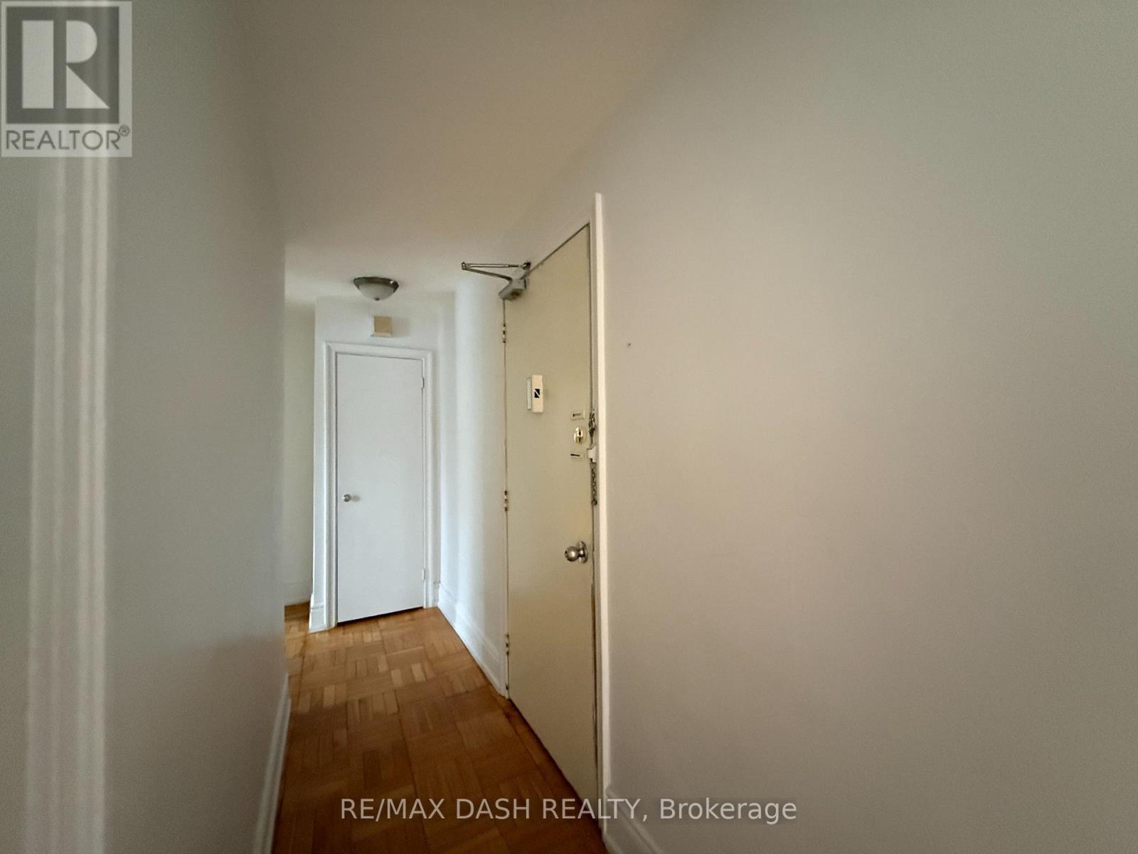 A hallway with a door at the end.