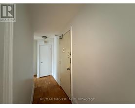 A hallway with a door at the end.