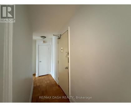 A hallway with a door at the end.